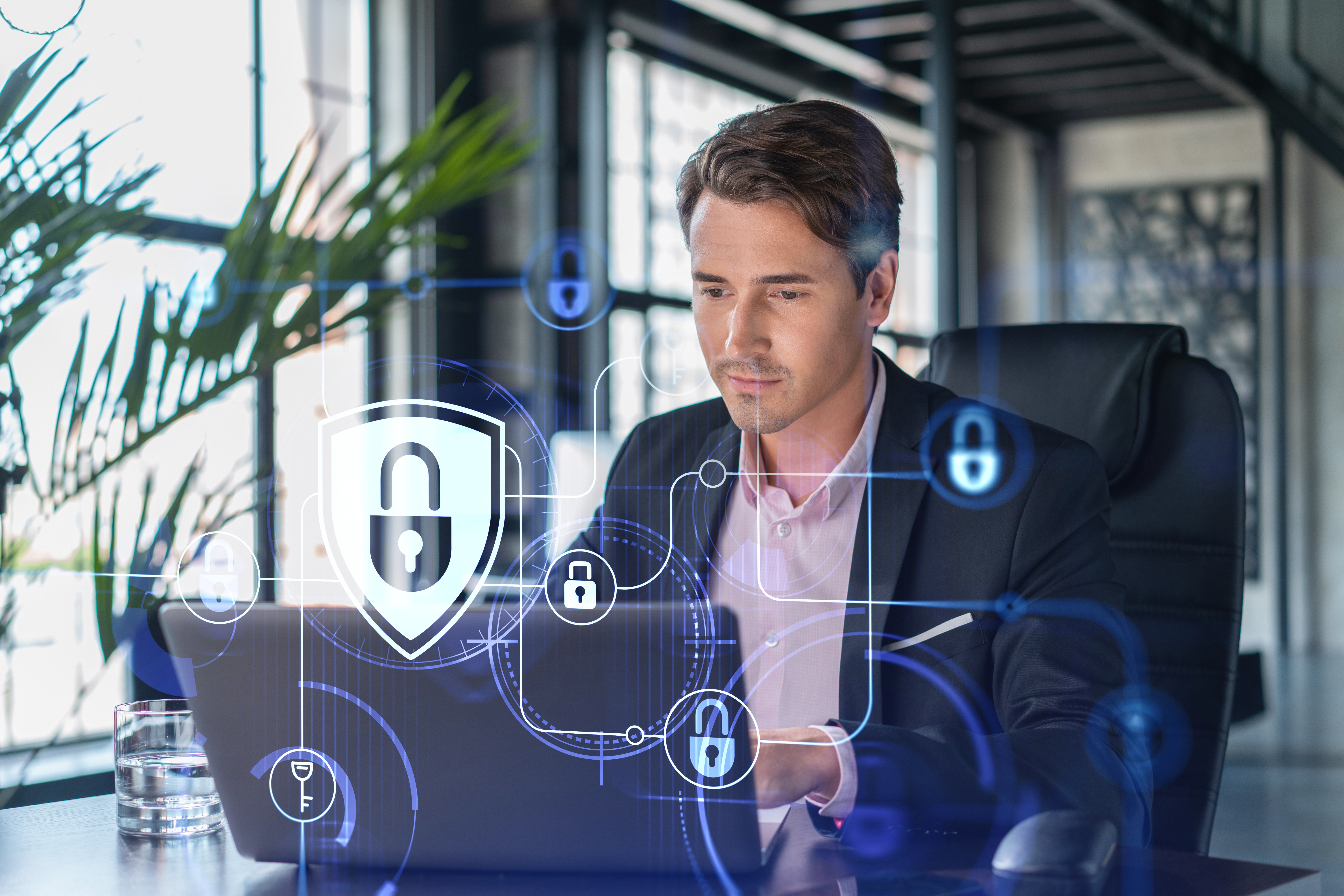 A man sitting at desk with a laptop cybersecurity
