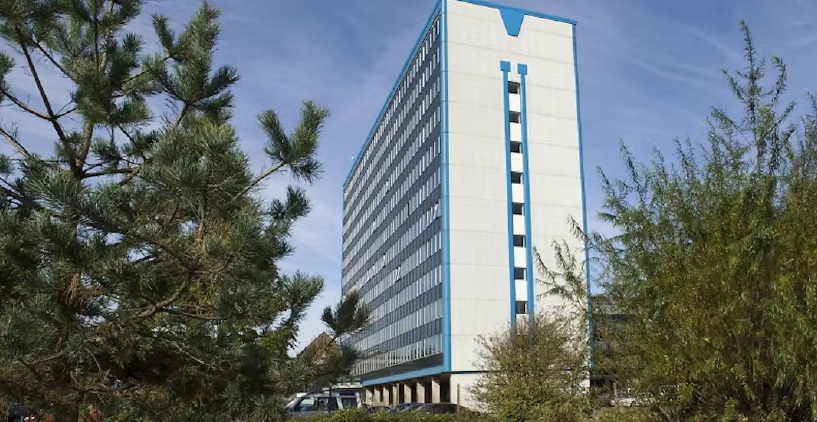 A sunny view along Southend Pier, Essex, showing the historic track, decorative bunting, and the Sir John Betjeman railway train against the background of the vibrant coastal town.