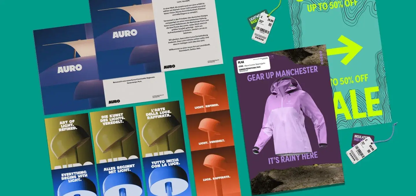 Promotional materials on a turquoise background, including brochures and sale tags. A poster features a purple raincoat with "Gear Up Manchester" text.