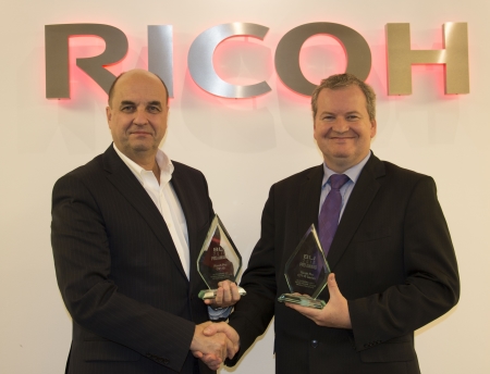 Benoit Chatelard, Vice President, Production Printing at Ricoh Europe receives an award from  David Sweetnam, Head of EMEA Research and Lab Services at BLI.