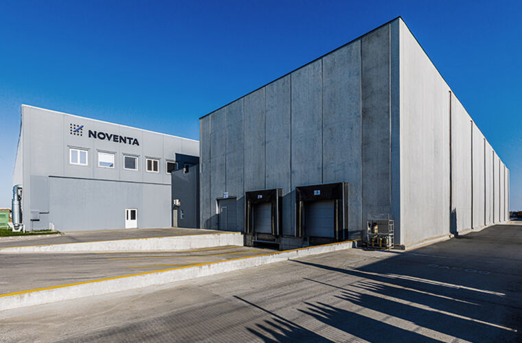 Large industrial warehouse facility under clear blue sky
