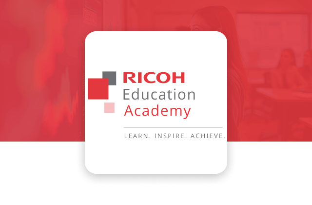 Ricoh Education Academy logo displayed on a white card against a red-tinted classroom background, featuring the text “RICOH Education Academy” and the tagline “Learn. Inspire. Achieve.”.