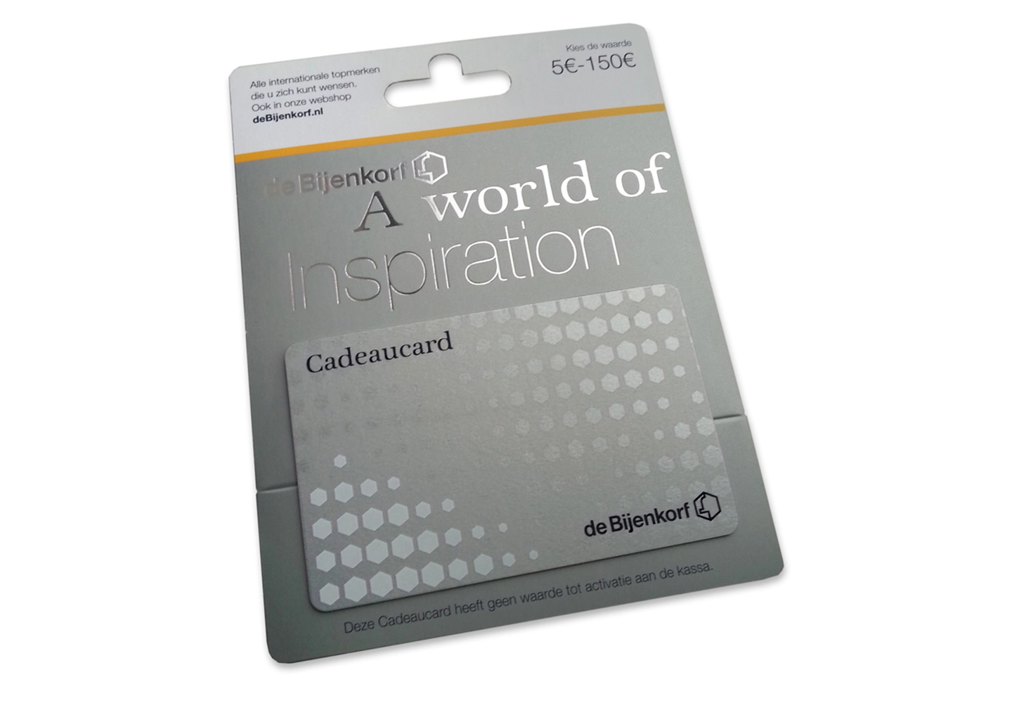 A silver gift card package from de Bijenkorf with "A world of Inspiration" text. Hexagonal design elements add elegance, suggesting luxury shopping.