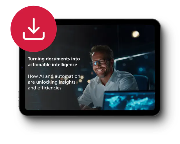 A smiling man in glasses works on a computer in a dimly lit office. Text reads: "Turning documents into actionable intelligence." A download icon is visible.