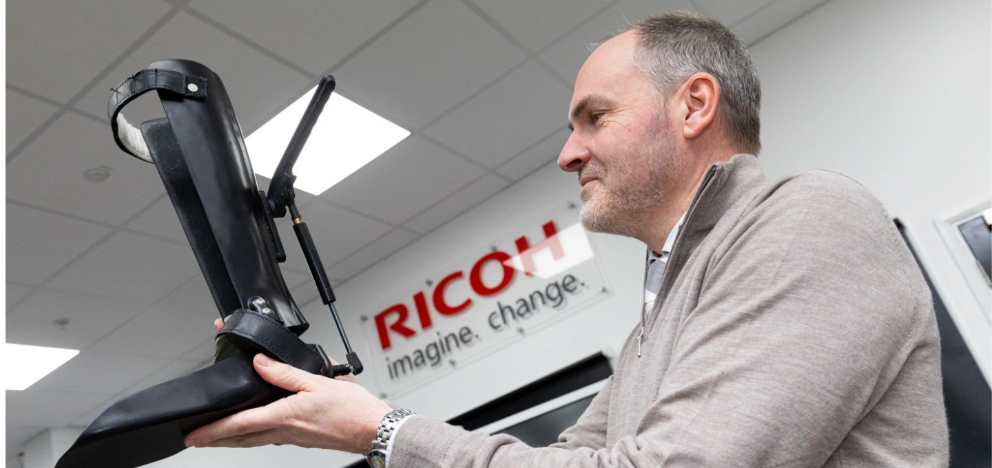 Keith Miller, Senior Rehabilitation Engineer (ORLAU), holding an ankle CCD.